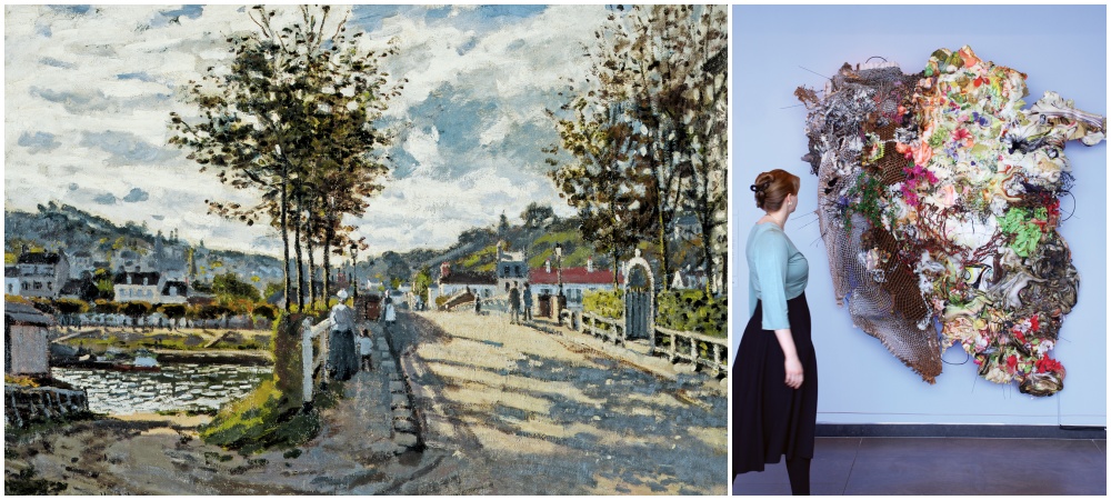 A person views an abstract mixed-media wall sculpture in a gallery; next to it is a painting of a street scene with trees and people under a cloudy sky.