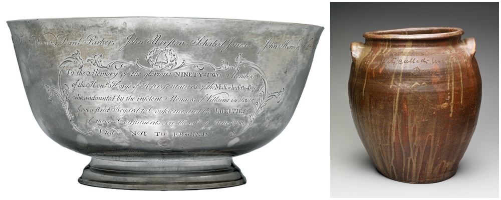 A large silver punch bowl with engraved text beside a brown glazed stoneware jar with handles and incised writing near the rim.