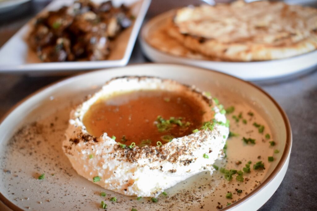 At Spanish River Grill in New Smyrna Beach, a plate of whipped feta cheese topped with fermented honey and black pepper.