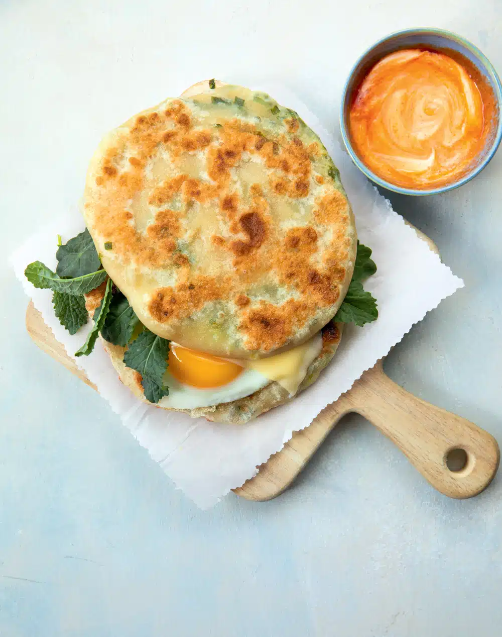 Egg, Cheddar, and Greens Sandwich on Scallion Pancakes